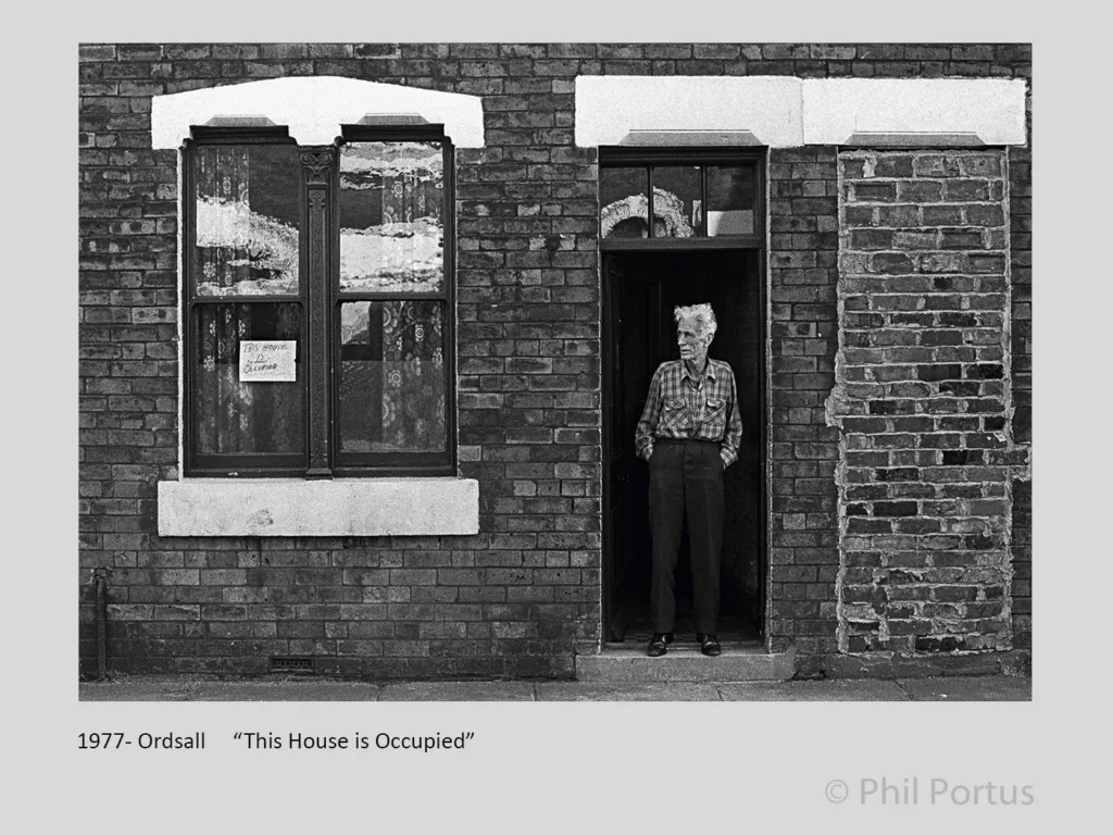 Mr Joe Hunter on Nashville Street  with sign "This house is occupied" during terraced house clearance. Ordsall, Salford, UK, 1978
