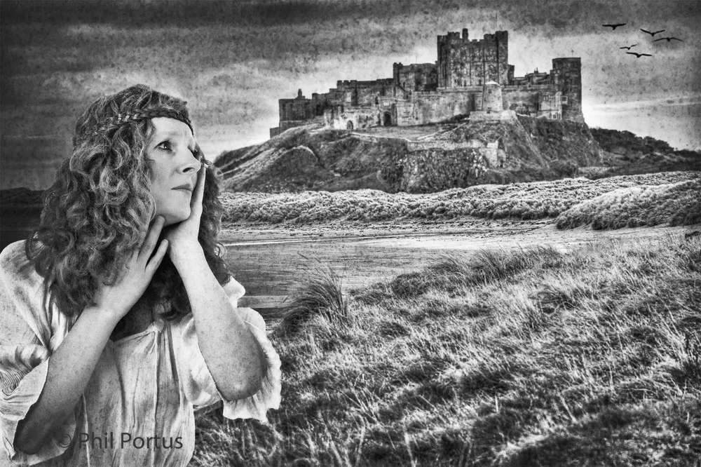 A person with long curly hair gazes upwards toward a large stone structure on a grassy hill.